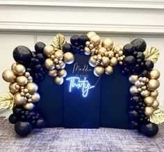 a blue and gold balloon arch decorated with balloons