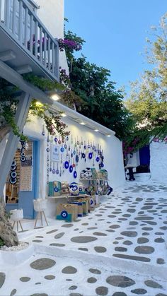 a white building with lots of decorations on the outside wall and stairs leading up to it