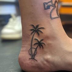 a small palm tree tattoo on the foot