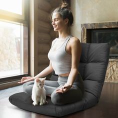 a woman sitting in a chair with her cat