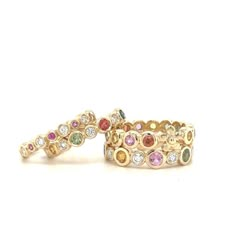 Our beautiful hand-made Primrose band set with Rainbow Sapphires and adorned by a single flower is set in yellow gold! Stack it with our other bands or wear by itself! 14k Yellow Gold Multicolored Sapphires Flower in band Can be worn as an Anniversary Band Size 6 1/2 *Please contact us at info@laurensigmancollection.com to inquire about an alternative size* Each band is unique and may have slight color differences than photos shown If not in stock, allow 4-6 weeks for delivery LS Collection Multicolor Stackable Fine Jewelry, Fine Jewelry: Multicolor Stackable Pieces, Multicolor Multi-stone Stackable Fine Jewelry Rings, Elegant Multicolor Stackable Jewelry, Multicolor Multi-stone Stackable Rings In Fine Jewelry Style, Elegant Multicolor Stackable Rings For Wedding, Elegant Multicolor Multi-stone Stackable Rings, Elegant Multicolor Stackable Rings, Elegant Multicolor Gemstone Stackable Rings