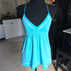 Y2k Nwt Hollister Bright Aqua Babydoll Tank Top. Ties In The Back, Cinched Under Bust, Deep V Neckline, Scattered Lace Overlay On Chest And Bottom Hem. 1st Pic And Last Pic Shows Truest Color! Size Medium, Could Fit A Small As Well. No Flaws. Y2k Sleeveless Beach Tops, Y2k Halter Neck Cotton Top, Y2k Stretch Tops For Vacation, Light Blue Spring Tops With Built-in Bra, Light Blue Tops With Built-in Bra For Spring, Blue Halter Neck Tops With Built-in Bra, Fitted Y2k Beach Tops, Y2k Style Fitted Beach Tops, Fitted Y2k Style Beach Tops