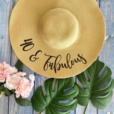 "This listing is for one custom floppy hat with your choice of hat color, text color, and phrase. If not specified, the default text for personalized hats is \"40 & Fabulous\". The hat is also available without personalization/text. No props are included. PRODUCT DETAILS: - Paper/straw floppy hat with iron on glitter vinyl (not embroidered) - One size fits most; includes an elastic strap for securing the hat - Hat measures 18 inches across, 7.75 inch crown/hat opening; 5.25 inch brim (wired Fun Summer Birthday Hat, Fun Curved Brim Hat For Birthday, Fun Curved Brim Hat For Birthdays, Summer Hats With Letter Print For Gifts, Summer Letter Print Hat For Gift, Vacation Sun Hat With Letter Print And Curved Brim, Curved Brim Hats For Birthday In Spring, Curved Brim Hats For Spring Birthday, Spring Curved Brim Hat For Birthdays