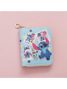 a small wallet with an image of stitchy and friends on the front, sitting on top of a pink surface