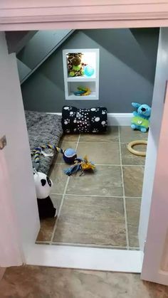 a child's room with toys and stuffed animals in the corner, viewed through an open door