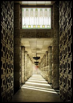 the hallway is lined with intricately designed walls and windows, along with a chandelier