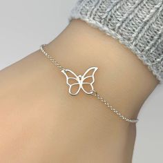 "Pictures are enlarged to show details of the item. Please refer to original size and measurements in the following description  Simple and adorable butterfly bracelet.  All components are sterling silver.  Butterfly measures 16x14mm. Adjustable length from 6.5\" to 7.5\". Simple and it looks good with anything!  ENTER OUR SHOP HERE for more jewellery : https://etsy.me/2yqbxk6 STORE POLICY: To make sure you're always 100% satisfied please read our store policies here prior to ordering: https://etsy.me/2RoEchD FOLLOW US on Facebook, Pinterest and Instagram: https://www.facebook.com/JewelleryByZM https://www.pinterest.co.uk/jewellerybyzm/ https://www.instagram.com/jewellerybyzm/" Silver Bracelet With Butterfly Clasp, Adjustable Dainty Butterfly Bracelet, White Butterfly Charm Bracelet For Gift, Silver Bracelet With Butterfly Clasp For Gift, Elegant Silver Bracelet With Butterfly Clasp, Delicate Silver Chain Bracelet As Gift, Butterfly Clasp Bracelets For Gift, Elegant Silver Butterfly Bracelets, White Butterfly Bracelet For Gift