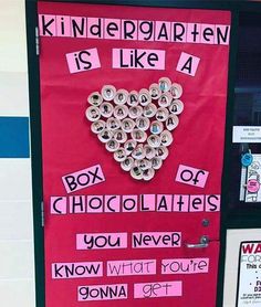 a bulletin board with words written on it and a heart made out of rolled up paper