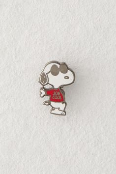 a pin with a dog wearing a red shirt