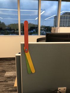 an office cubicle with a pair of scissors sticking out of it's side