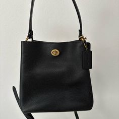 Coach Black Leather Handbag. Can Be Used With Small Strap Or Crossbody With Long Strap (Both Included). Used Like New. Versatile Coach Bag With Gold-tone Hardware, Classic Bucket Bag With Branded Hardware For Daily Use, Classic Black Bucket Bag With Removable Pouch, Black Bags With Branded Hardware For On-the-go, Versatile Coach Bag With Adjustable Strap, Office Crossbody Bag With Snap Closure, Coach Bucket Shoulder Bag With Branded Hardware, Coach Crossbody Shoulder Bag For Everyday Use, Classic Bucket Bag With Branded Hardware