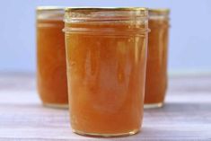 three jars filled with liquid sitting on top of a table