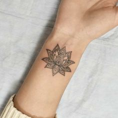 a woman's arm with a tattoo on it and a flower in the middle