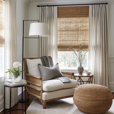 a living room filled with furniture and a window covered in bamboo blind shades on the windowsill