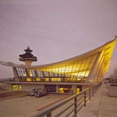 a large building with a curved roof at dusk