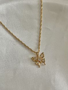 This beautiful butterfly necklace is made with a dazzling 18K gold plated butterfly pendant and chain. The necklace makes for an exquisite everyday accessory. The butterfly pendant features four sparkling crystals that elevate the look of the necklace.  With the perfect combination of comfortable, affordable, and quality, this necklace is sure to be an everyday  staple in your jewelry collection.  Length: 16inches.  Material: All findings, chain, and pendant are 18K Gold-Plated over brass.  Hand Chain And Pendant, Brass Hand, Butterfly Pendant Necklace, Everyday Accessories, Butterfly Necklace, Butterfly Pendant, Sparkling Crystal, The Butterfly, Beautiful Butterflies