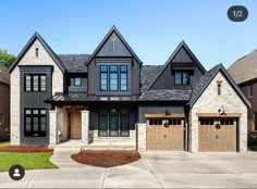 a large house with two garages and three windows