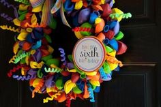 a colorful wreath is hanging on the door