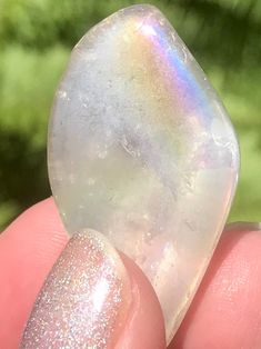 Tumbled Angel Aura Quartz Stones Peace Angel Aura Quartz or Rainbow Aura Quartz cleanses the aura and can help to facilitate meditation. This is a very peaceful stone which can help the wearer communicate with Angels and Spirit Guides. This stone will help you clear away the negativity in your life. It will also raise the energy level of anyone who has been feeling depleted. Angel Aura Quartz can help you release negative emotions, such as resentment and grief. Stones measures 1 to 1 and 1/2 inc Spiritual Tumbled Crystals For Meditation, Iridescent Healing Spiritual Crystals, Iridescent Spiritual Healing Crystals, Spiritual Iridescent Healing Crystals, Rainbow Aura Quartz, Rainbow Aura, Angel Aura Quartz, Angel Aura, Negative Emotions