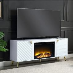 a television stand with a fireplace in the center