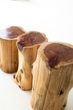 three wooden stools sitting on top of a white table