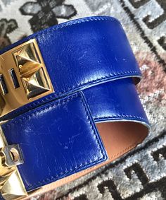 "For Size 65, the Kelly belt is also available for sale: https://www.etsy.com/listing/487819728/mint-vintage-hermes-black-box-calf 1990s. Vintage Hermes Collier de Chian blue/ Calfskin Medor belt with gold-plated hardware. Size 65. Fit for 24.4\"-25.5\"(62~ 65cm), based on belt holes. Introducing one of the most masterpiece accessories from Hermes back in the 90's. Rare blue color boxcalf leather belt, known as \"Collier de Chien\" with golden hardware, stamped T in O, 1990. Both golden brass an Designer Formal Belt Buckles With Gold-tone Hardware, Designer Belt Buckles With Gold-tone Hardware For Formal Wear, Designer Gold-tone Belt Buckles For Formal Wear, Luxury Evening Belts With Gold-tone Hardware, Blue Leather Belt Buckles With Removable Belt, Luxury Blue Belt For Formal Occasions, Luxury Blue Formal Belt, Elegant Blue Leather Belt, Luxury Blue Leather Belt