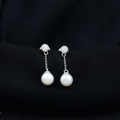 Product Details Simple and classic, with a 7 MM Freshwater Pearl Drop suspended from a Bezel Set Diamond Solitaire adding to the brilliant look of these Chain Earrings. Product Information SKU SHP-EARRINGS032014164 Length 40 mm Width 7 mm Height 7 mm Weight 1.36 gm (Approximate) FRESHWATER PEARL INFORMATION No.of Stones 2 Pieces Total Weight 6.00 Carat (Approximate) Dimension(approx) Round-7X7 mm-2 Pcs Color White Cut Brilliant Shape Round Setting Type Bead-Set Quality Grade AAA DIAMOND INFORMAT Elegant Timeless Earrings For Anniversary, Elegant Earrings With Timeless Design, Elegant Earrings With Timeless Design As Gift, Elegant Diamond White Jewelry With Timeless Design, Elegant Gift Earrings With Timeless Design, Elegant Timeless Design Earrings As Gift, Elegant Timeless Diamond White Jewelry, Elegant Timeless Design Jewelry For Formal Occasions, Elegant Timeless Jewelry For Formal Occasions