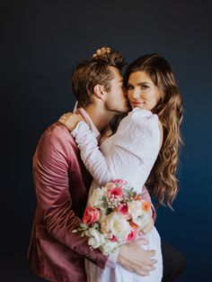 a man and woman are hugging each other