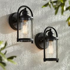 two outdoor lights on the side of a wall