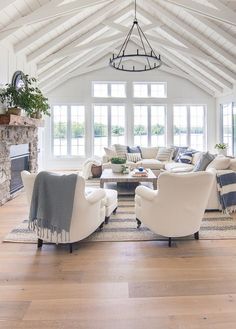 a living room filled with furniture and a fire place in the middle of an open floor plan