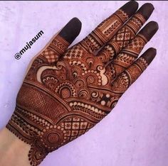 a hand that is decorated with henna on the top and bottom half of it