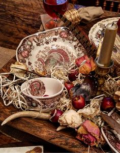 an arrangement of dishes and utensils on a table