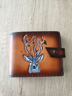 This is a completely handcrafted wallet - from start to finish. To make it, est. were used genuine vegetable tanned calf leather, Feebings leather paint, acrylic paints for the drawing as well as Tokonole and a special protective finish to protect the leather. The wallet is unique and can never be duplicated, as the entire process of creating it is completely manual. This is a product for people who love the unique and unrepeatable. The wallet has the following dimensions in the closed position:  115 mm x 95 mm x 20 mm / 4.5 in x 3.7 in x0.8 in There are - 3 pockets for carts - 1 long pocket for money - 1 pocket for coin - 1  hidden pocket behind the pocket for coin As this is a handmade item, there may be slight scratches on the leather, which does not affect the overall quality in any wa Artisan Hand-stitched Wallet As Gift, Custom Handmade Trifold Wallet, Custom Handmade Rectangular Trifold Wallet, Brown Hand Tooled Trifold Wallet As Gift, Custom Handmade Brown Trifold Wallet, Hand Tooled Brown Wallets As Gift, Rustic Handmade Bifold Wallet, Artisan Hand-tooled Wallets For Gifts, Custom Handmade Brown Wallet