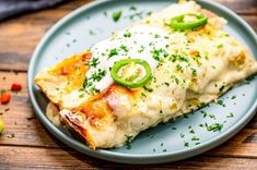 two pieces of pizza on a blue plate with green peppers and sour kraut