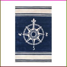 a blue and white rug with a compass on the front, and an anchor in the middle