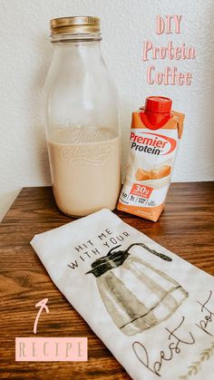 a bottle of milk next to a tea towel on a table