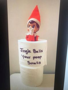 an elf is sitting on top of a toilet paper roll that says,'single bells your pop smells '