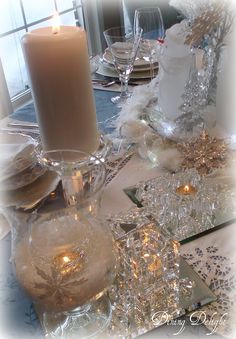 the table is set with candles and dishes