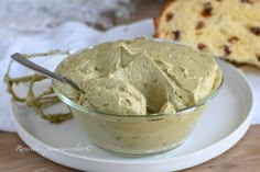 a white plate topped with a bowl of hummus