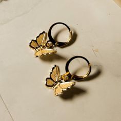 Butterflies are known for their mesmerizing beauty, strength, and hope. Feel empowered wearing our ultra featherweight butterfly wings. The Kimi Butterfly is super dainty and the perfect minimalist earring for any lover of butterflies. This earring is also a lovely gift for anyone who has recently "transformed" into a new chapter in their life (graduation, accomplishment, new job, birthday). ⬩13mm Butterfly shape ⬩Huggie Hoop style Hypoallergenic Brass wire⬩.75 inch Dangle earring Adjustable Drop Earrings With Butterfly Charm, Trendy Butterfly Hoop Earrings As Gift, Dainty Hoop Earrings With Butterfly Charm, Dainty Butterfly Earrings For Everyday Wear, Dainty Butterfly Nickel-free Earrings, Dainty Butterfly Charm Earrings, Elegant Adjustable Earrings With Butterfly Charm, Dainty Nickel-free Butterfly Earrings, Butterfly-shaped Hypoallergenic Hoop Earrings For Gifts