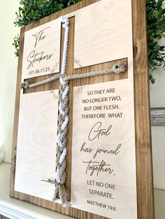 a cross made out of wood and rope on top of a mantle