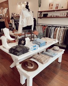 a table with clothes and hats on it