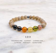 From July 23 to August 22, the Sun is in Leo ♌️ This Leo zodiac bracelet is designed with natural gemstones specifically for Leo astrology sign. It compliments and enhances Leo peace, harmony and well being. It is made of the following crystals: Tourmaline, Garnet, Carnelian, Citrine, Peridot and Sunstone. (Check photos to see how the gemstones work with Leo energy.) ● You can select Black Lava or Wood Jasper as the complementary gemstones. The beads/stones are strung on high quality elastic str Spiritual Zodiac Beaded Bracelets For Healing, New Moon In Leo Crystals, Leo Crystal Bracelet, Leo Zodiac Crystals, Zodiac Crystal Bracelet, Balance Bracelet, Astrology Jewelry, Healing Stones Jewelry, Zodiac Bracelet