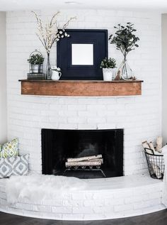 an instagram page with a fireplace and potted plants on the mantel above it