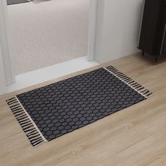 a black and white rug on the floor next to a radiator