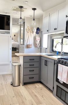 In this complete RV renovation we took the whole kitchen out and rebuilt custom light weight cabinetry. The countertops are birch butcher block and for the backsplash we used a glass mosaic tile. Rv Kitchen Sink Remodel, Camper Kitchen Remodel, Fifth Wheel Remodel, Home Depot Flooring, Trailer Caravan, Camper Remodel Ideas, Motorhome Remodel, 5th Wheel Camper