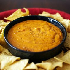 tortilla chips and dip in a black bowl