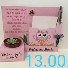 a pink photo frame with an owl on it next to a succulent plant