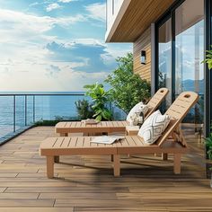 two lounge chairs sitting on top of a wooden deck next to an ocean side building