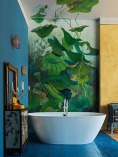 a bathroom with blue tile floors and a large painting on the wall above the bathtub